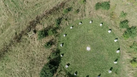 Spinning aerial dropping low over a pagan-like stone circle grove. Devon, Stock Footage 94904861