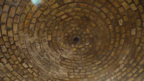 Spinning ancient brick dome ceiling with radiating light flare in historic Stock Footage 341869074
