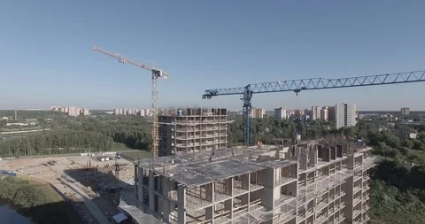 Spinning around construction site of multistory apartment building near river Stock Footage 105080184