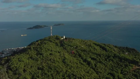 Spinning around long cable car over several islands in sunset above mountain wit Stock Footage 124366918