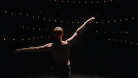 Spinning ballerina on stage in dramatic light, ballet dancer rehearsing Stock Footage 208738952