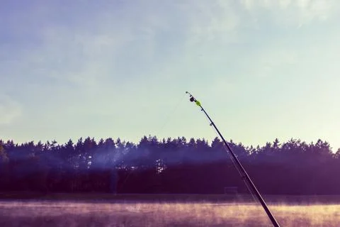 Spinning. the bell is twitching. there is a bite. late evening. focus on th.. Stock Photos