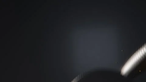 Spinning bimetallic coin entering upper-right, drifting over navy glow, Stock Footage 337885992