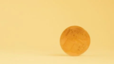 Spinning bitcoin on light yellow background Stock Footage 241483151