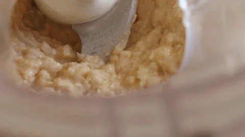 Spinning Blades of a Food Processor Blend Homemade Hummus Stock Footage 77560656