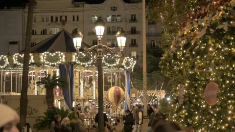 Spinning carousel beside Christmas tree in Valencia Stock Footage 296009978