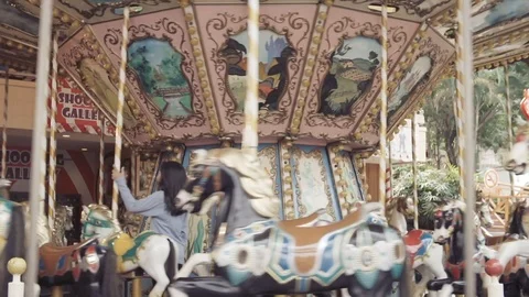 Spinning carousel with horses in theme park Stock Footage 105586374