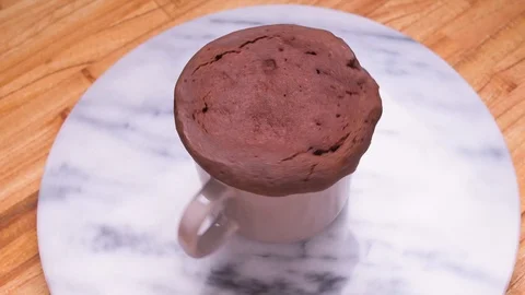 Spinning Chocolate Cake in a Mug on Marble Over Wood Video stock 128162845
