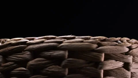 Spinning close-up of a dark brown, natural wicker basket, a testament to sk.. Stock Footage 264501495