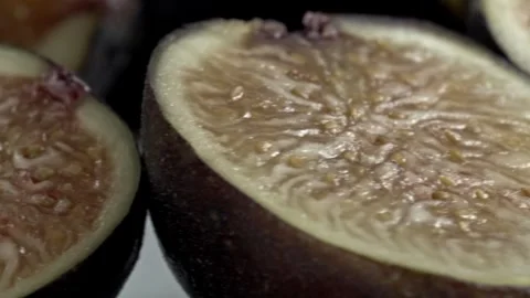 Spinning Closeup of Fresh Fig Half Showing Detailed Interior and Seeds on Dark 스톡 동영상 344499872