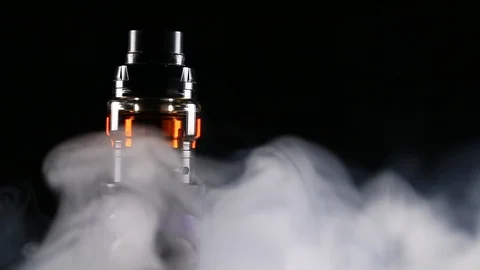 Spinning Closeup of Vape Mod with Black Background and Clouds of Vapor Stock Footage 103120892