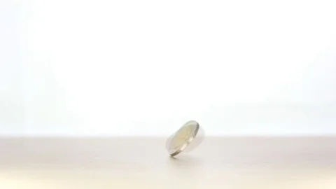 Spinning coin on white background Stock Footage