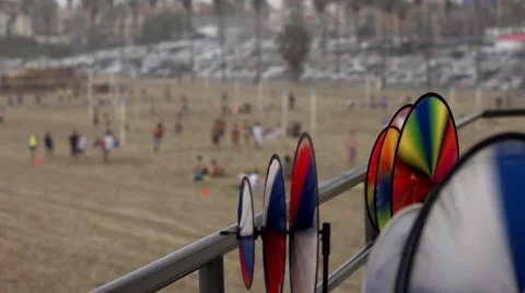 Spinning Color Wheels Frame Beachgoers in California Video stock 50630522