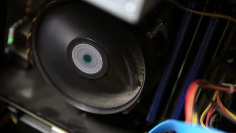 Spinning CPU cooler fan inside computer case showing internal hardware of Stock Footage 329213350