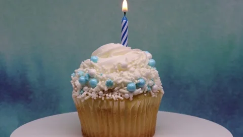 Spinning cupcake with candle Stock Footage 238607986
