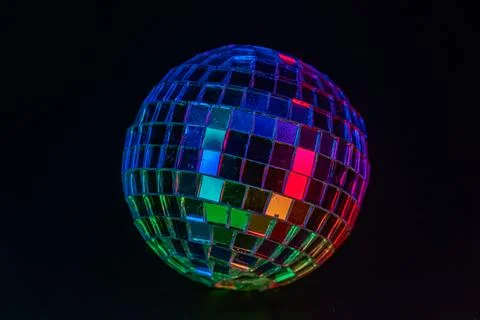 A spinning disco ball casting vibrant colors, symbolizing party events or nos Stock Photos