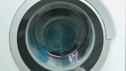 Spinning Drum of the Washing Machine with the Laundry close-up. The process of w Stock Footage 130814934