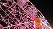 Spinning Ferris Rainbow Wheel Ride Or Carousel In The Amusement Park At Night Stock Footage