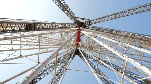 Spinning ferris wheel on sunny day Stock Footage