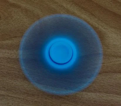 Spinning the fidget spinner Stock Photos