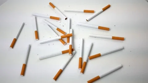 Spinning generic cigarettes spinning over white - Overhead View Stock Footage 84173139