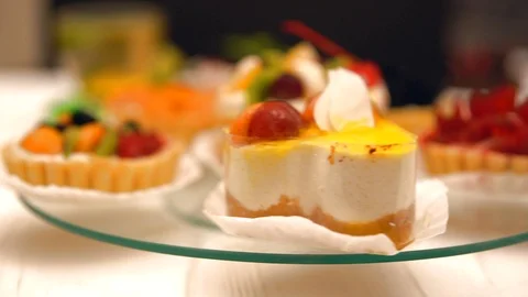 Spinning glass stand with assorted baked desserts Video stock 94090428
