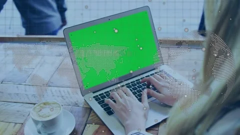 Spinning globe and world map with data processing over woman using laptop with Stock Footage 330058033