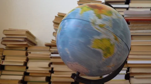Spinning globe on the background of books Stock Footage 128408510