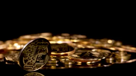 Spinning Gold Cryptocurrency Coin on Stack in Dark Studio Stock Footage 316672763