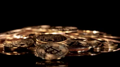 Spinning Golden Cryptocurrency Coin on Stack of Tokens Video stock 315640213