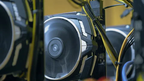 Spinning graphics card cooling fan inside active open GPU mining rig Stock Footage 345932541