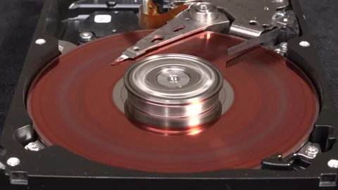 Spinning hard drive, colored red, with shutdown and surface cleaning - C0019 Stock Footage 320835629