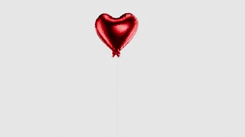 A spinning heart-shaped balloon. A red, shiny heart-shaped balloon for a Stock Footage 325860066