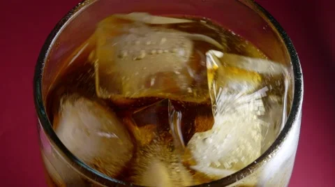 Spinning ice cubes in cola Stock Footage 64848878