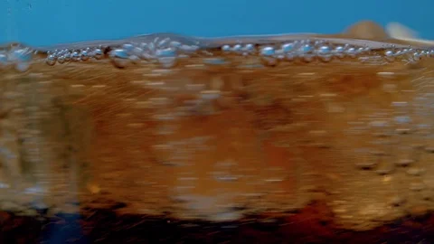 Spinning ice cubes in cola Stock Footage 123999894