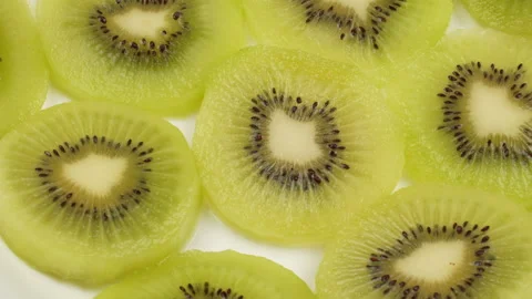 Spinning Kiwi Slices Pattern Top Down Loop on Wooden Board Stock Footage 319915531