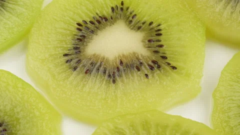 Spinning Kiwi Slices Pattern Top Down Loop on Wooden Board Stock Footage 319915631