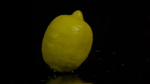 Spinning lemon in slow motion on a black... | Stock Video | Pond5