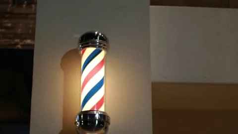 A spinning lighted barber shop pole Stock Footage 143810484
