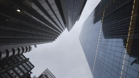 A spinning low angle view of high raise glass office buildings. Video stock 103256488