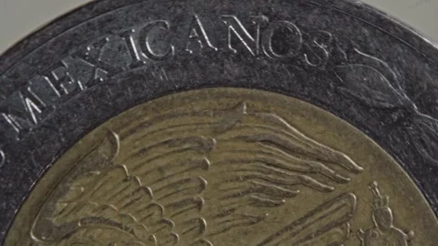 Spinning Mexican Coin With Eagle and Snake Engraving in Close Up View Mexico Stock Footage 346745170