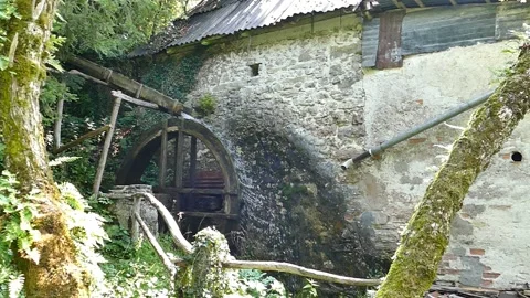 Spinning Old Mill Wheel, side view, slow motion Stock Footage 144976511