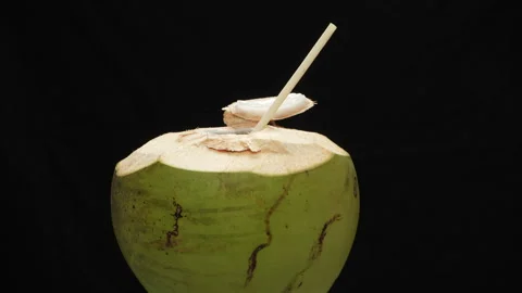 Spinning Opened Coconut Drink with Straw Loop Isolated on black Stock Footage 319905501