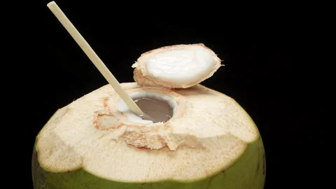 Spinning Opened Coconut Drink with Straw Loop Isolated on black Stock Footage 319907568