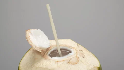 Spinning Opened Coconut Drink with Straw Loop Isolated on white Stock Footage 319908050