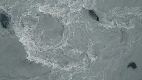 Spinning over rushing grey river Stock Footage 140611138