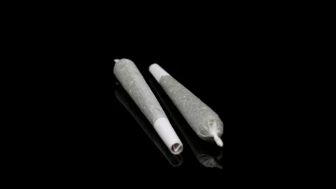 Spinning Pair of Rolled Up Marijuana Joints Loopable Video stock 108590466