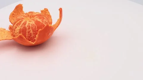 A spinning peeled orange Stock Footage 336656517