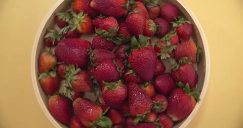 Spinning Plate of Strawberries on a Solid Yellow Background Stock Footage 240656846