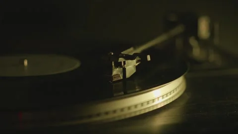 Spinning record on DJ turntable lit by vintage color lights, calm mood for .. Video stock 310822748